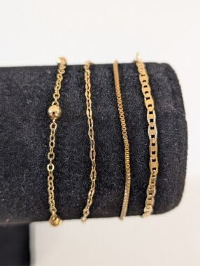Set Of Four Gold Tone Chain Link Bracelets With Extenders